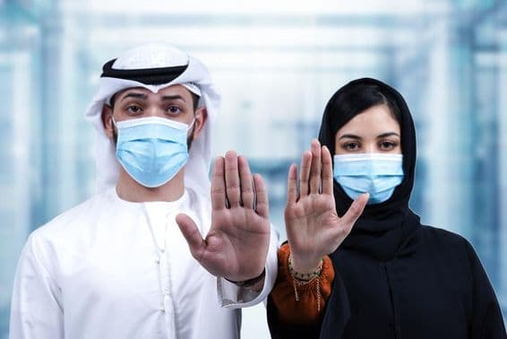 Arab férfi és nő arc orvosi maszkban mutatja stop gesztust.